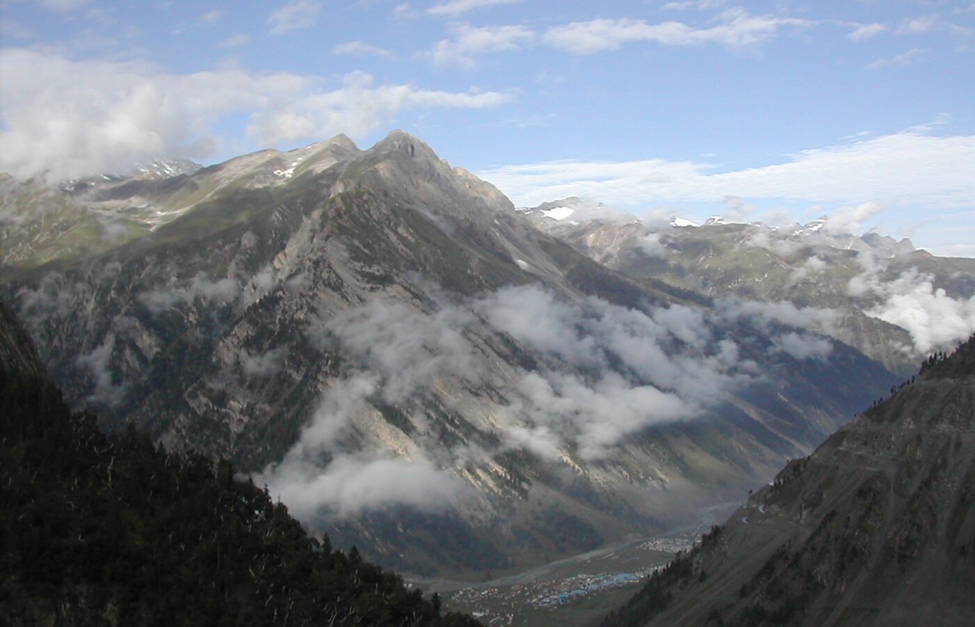 A convoy road winding over a high Himalayan pass