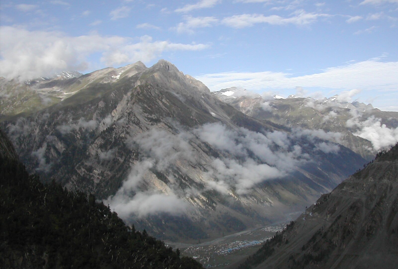 A convoy road winding over a high Himalayan pass