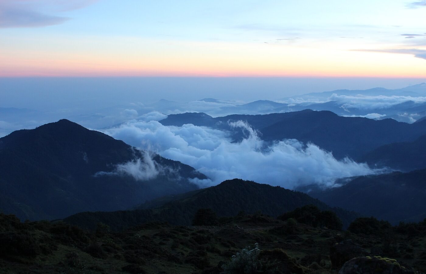 A high ridge trail in the eastern Himalaya with distant snow peaks